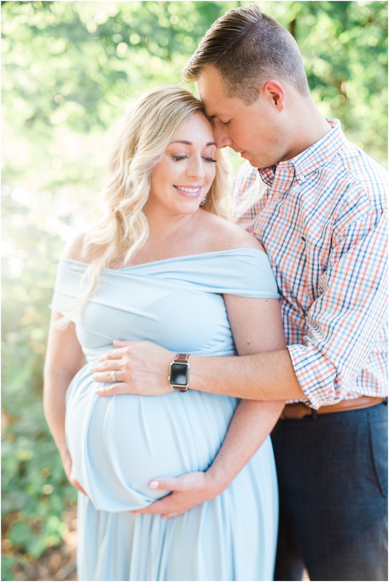 Couple holding pregnant belly